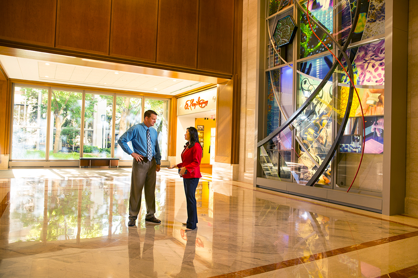 Two Lilly employees having a discussion outside of Lilly's Heritage Hall at the Lilly Corporate Center in Indianapolis